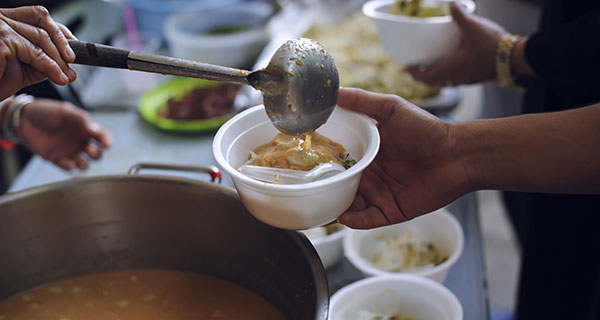 Food being ladled into a bowl
