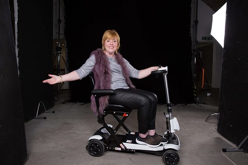 Hayley on a mobile scooter smiling