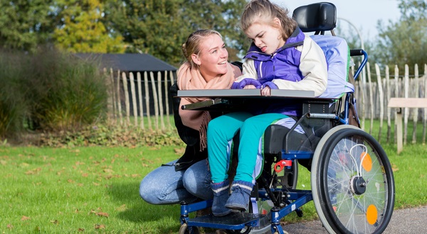 Carer with a child in a wheelchair