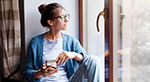 Young woman sitting by a window