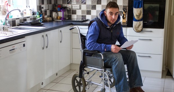 Man sitting in a wheelchair in a kitchen