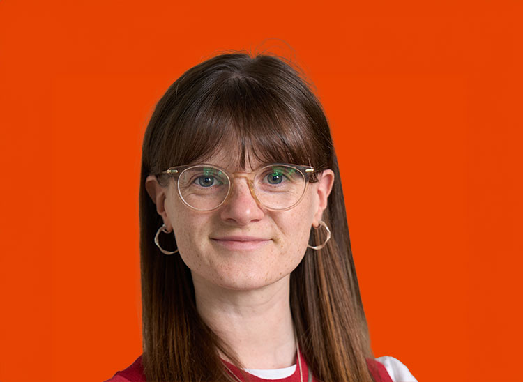 Lucy Bannister with long brown hair and glasses