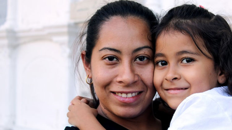 Mother holding child - both smiling
