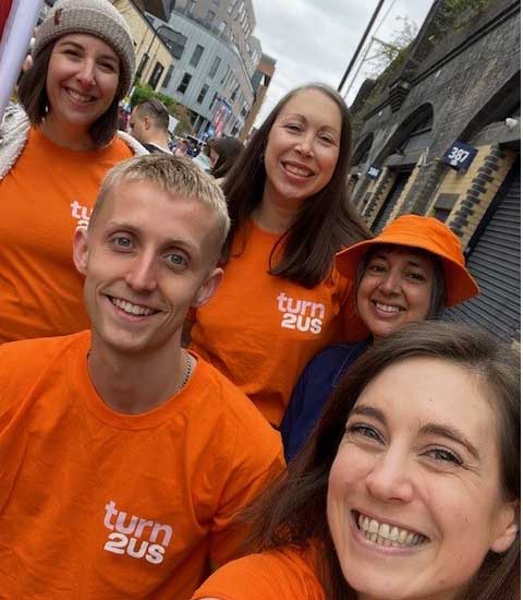 Turn2us employees wearing orange t-shirts at a fundraising event