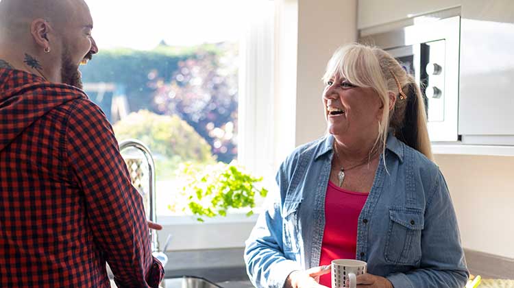 Woman and man talking in a kitchen