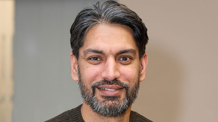 Umar Ansari wearing khaki green jumper