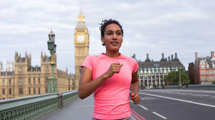 Woman runner in pink top with London's Big Ben in the background