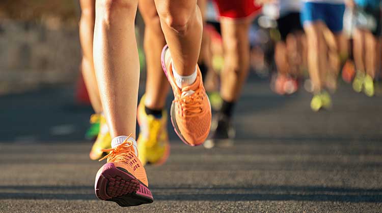 Runners competing in a race - shown from the knee downwards