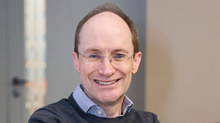 Tim Leunig wearing blue shirt and grey jumper