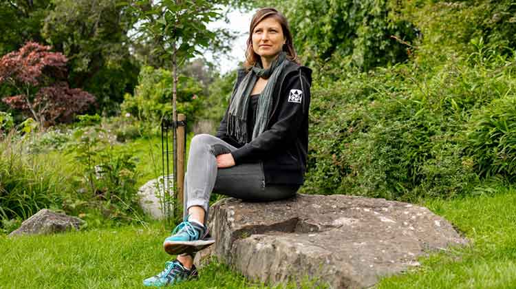 Smiling woman sitting in garden