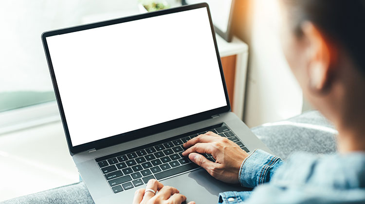 Woman typing at laptop