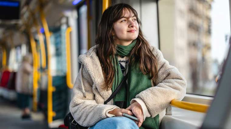 Woman with long dark hair looking out of a train window
