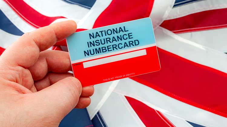 National Insurance card held up against the Union Jack flag