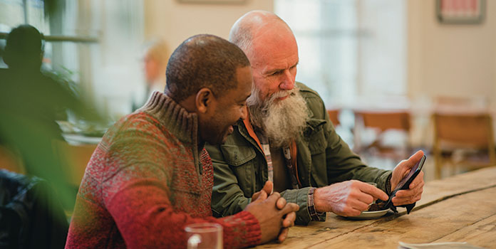 Two men sitting in a cafe in conversation