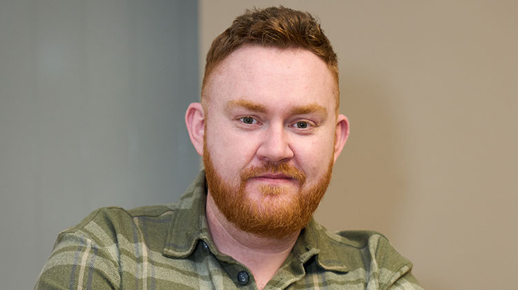 John Loughton with short red hair and beard wearing green check shirt